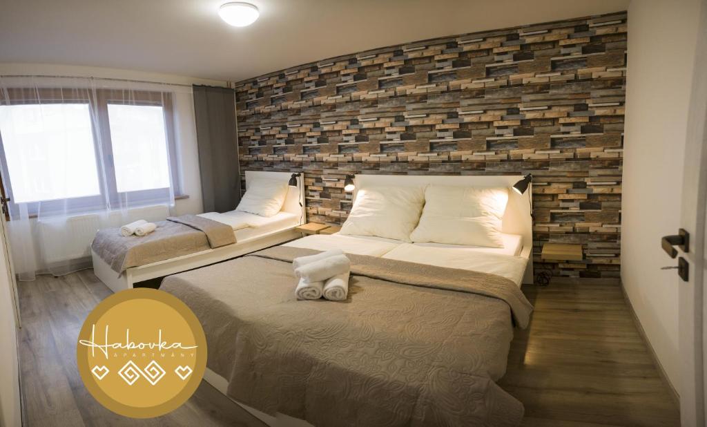 Postel nebo postele na pokoji v ubytování Apartmány Habovka