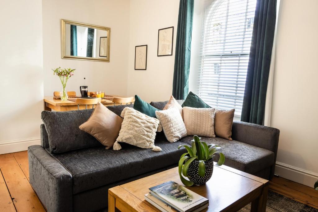 a living room with a couch and a table at Central Plymouth Georgian Apartment - Sleeps 5 - Private Parking - By Habita Property in Plymouth