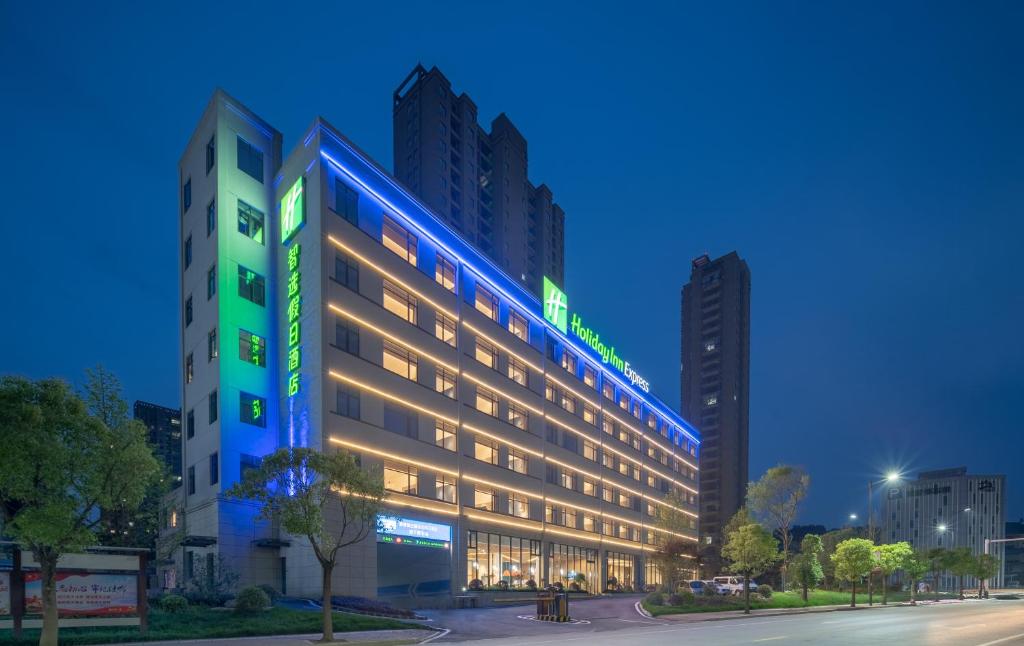 a large building with lights on it at night at Holiday Inn Express Jingdezhen Ancient Town, an IHG Hotel in Jingdezhen