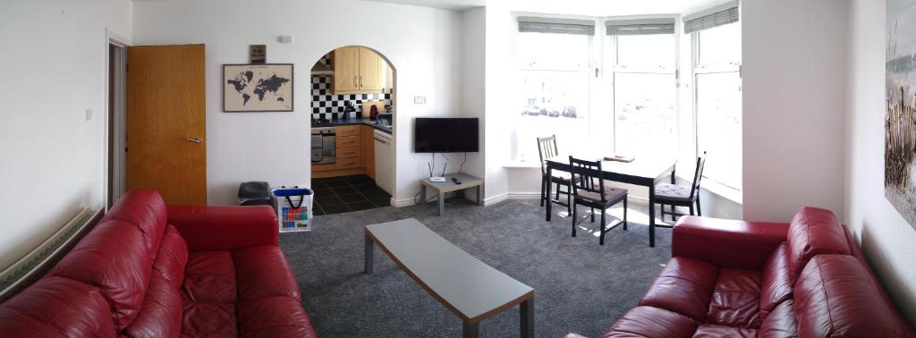 a living room with a couch and a table at The Gateway Guest Apartment in Portstewart
