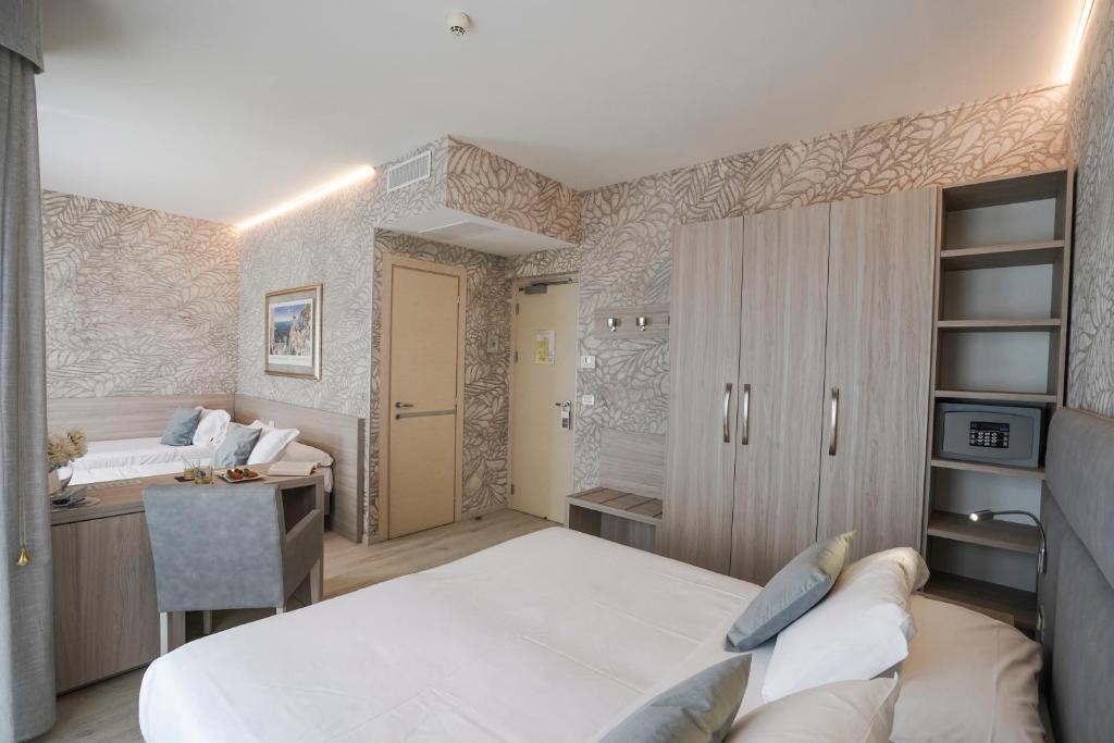 a bedroom with a bed and a desk in a room at Sole Mare in Ventimiglia