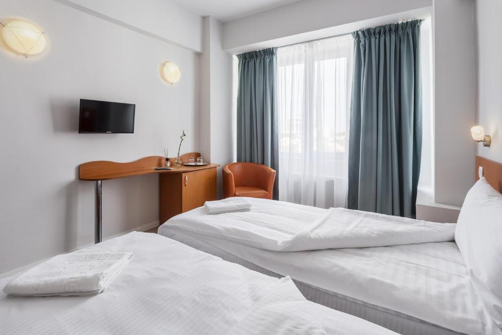 Postel nebo postele na pokoji v ubytování Elizeu Hotel