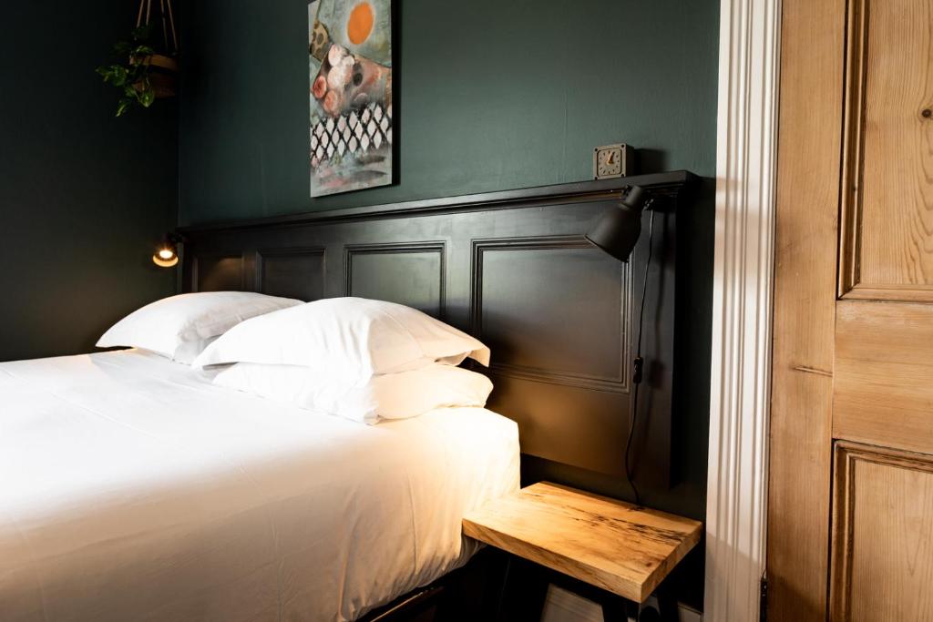 a bedroom with a bed with a table next to it at The Old Vicarage in Cardigan