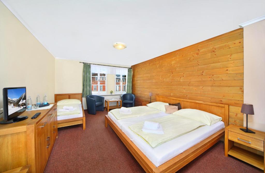 Postel nebo postele na pokoji v ubytování Hotel Erika