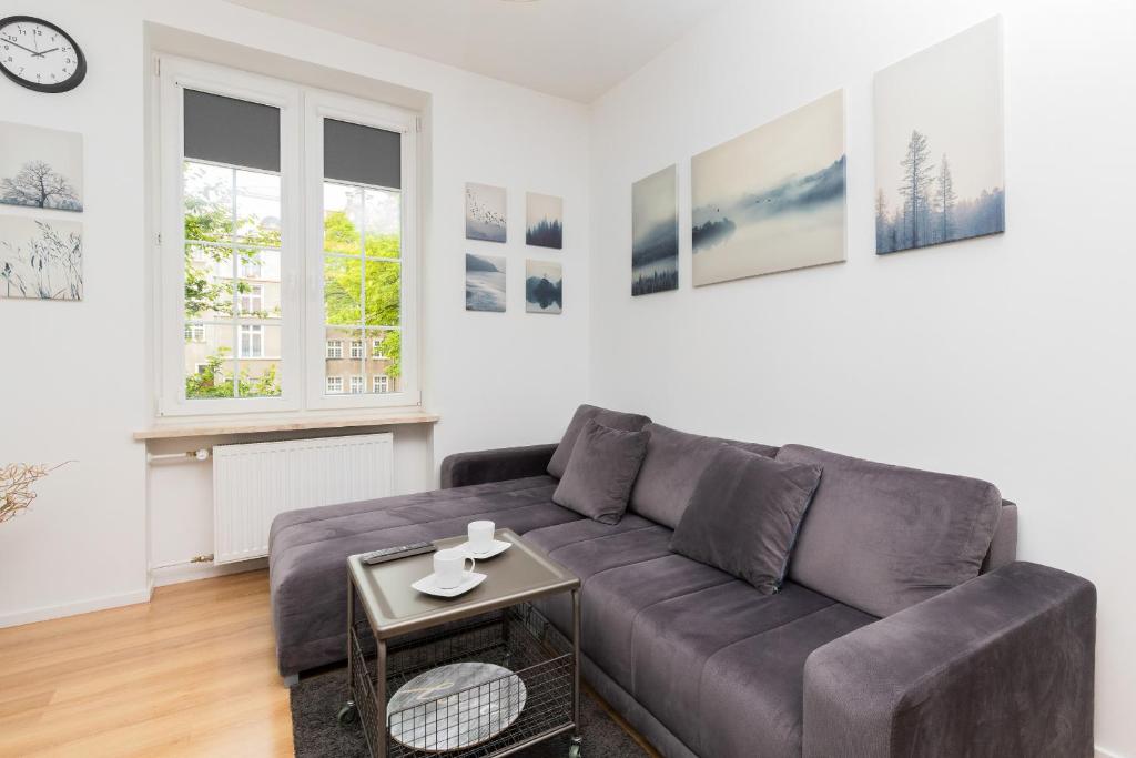 a living room with a couch and a table at Chlebnicka Apartments in Gdańsk Old Town by Renters in Gdańsk
