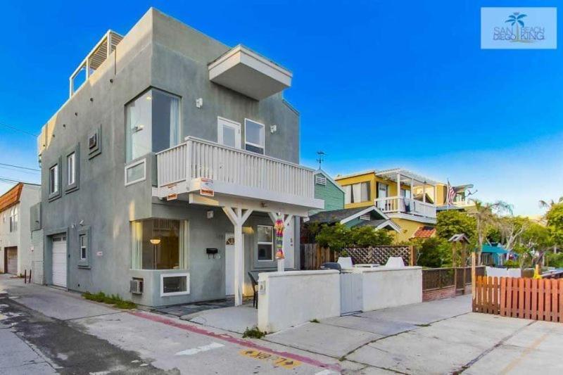 a large gray house with a balcony on a street at 199-surf Stars Combo in San Diego