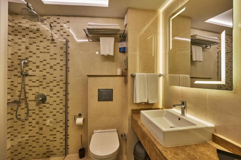 a bathroom with a sink and a toilet and a shower at Grand Hotel Gulsoy Old City in Istanbul