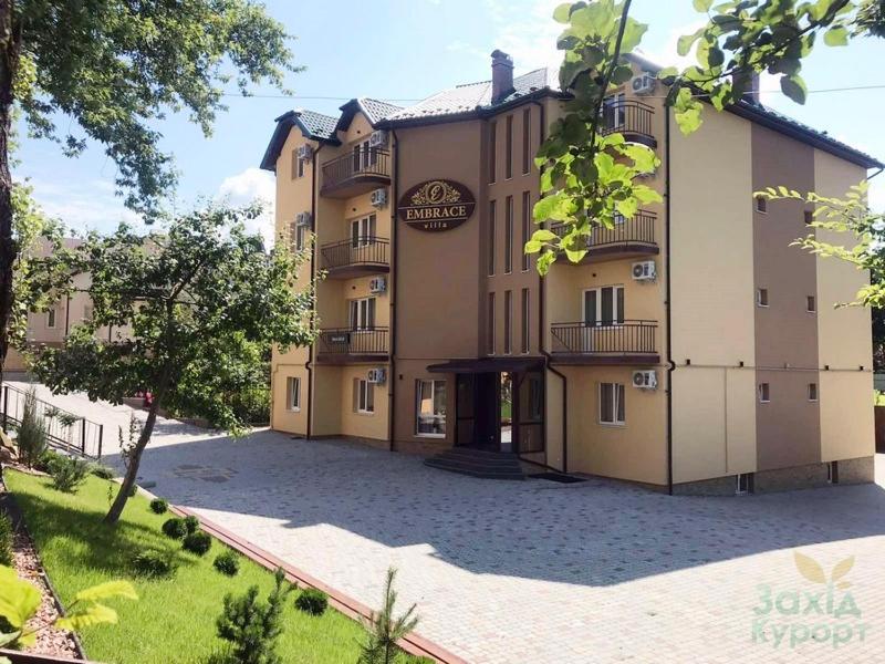 un gran edificio con un patio delante de él en Embrace en Truskavets