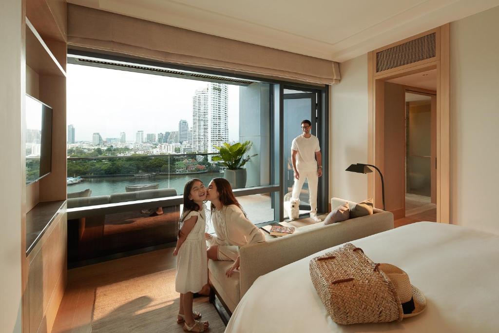 A family-oriented bedroom and sitting area opening toward a river view.