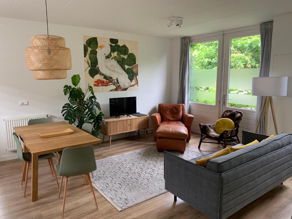 a living room with a couch and a table at Guest House Amersfoort Center in Amersfoort