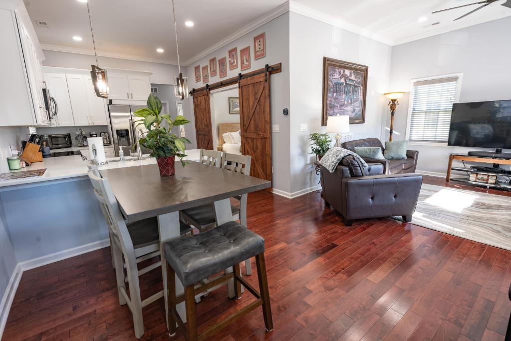 a kitchen and living room with a table and chairs at Remodeled Historic House Walkable to Everything in Raleigh