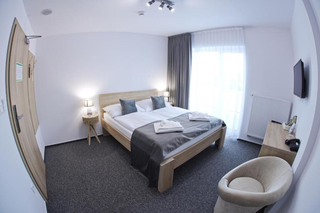 Postel nebo postele na pokoji v ubytování Hotel Prístav