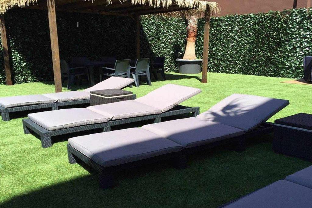 a group of beds sitting on the grass at Ed Senses Apartamento Freedom in Tarifa