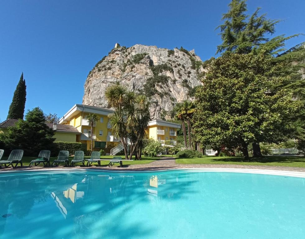 a swimming pool in front of a mountain at Hotel Garden Arco in Arco