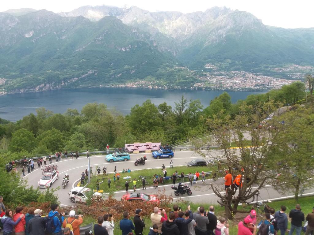 a crowd of people standing around a road with a lake at BIKE-HOTEL BELLAGIO MIRABEAU in Bellagio