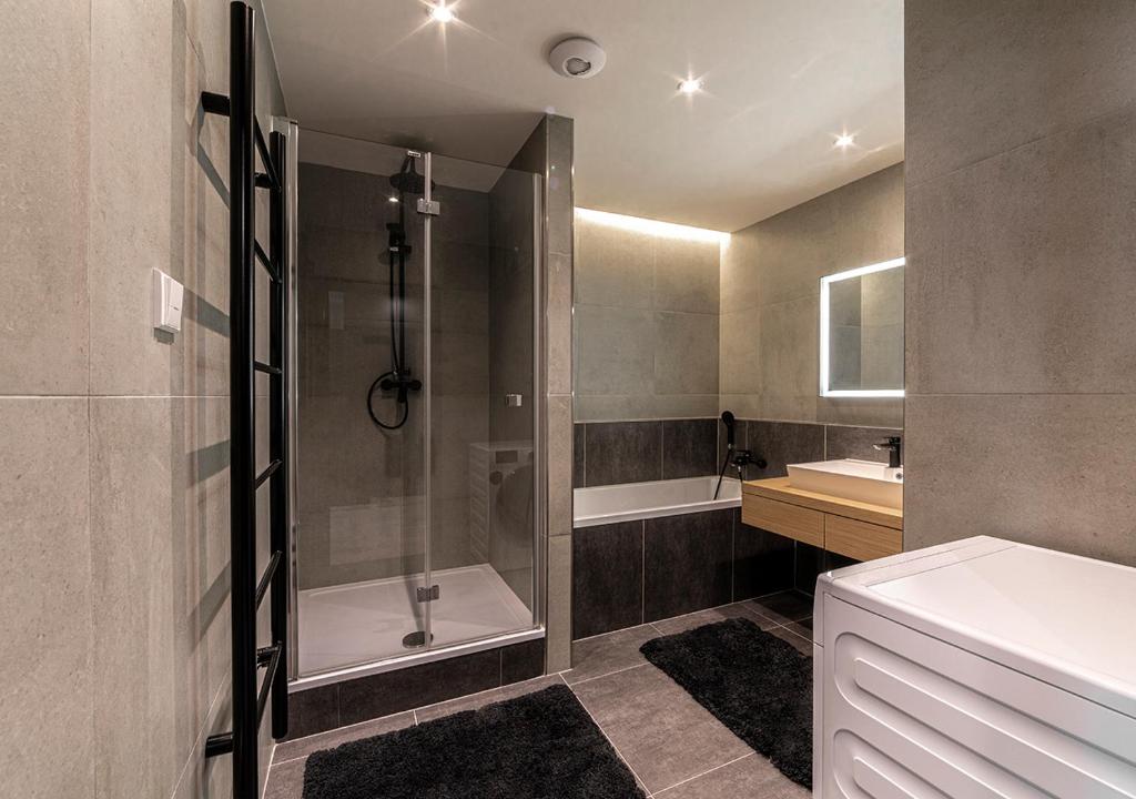 łazienka z prysznicem, wanną i umywalką w obiekcie Gesto Apartments w Pradze