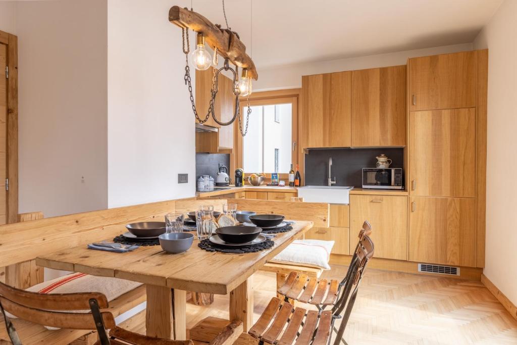 a kitchen with a wooden table and chairs at Casa Olimpia in Cortina dʼAmpezzo