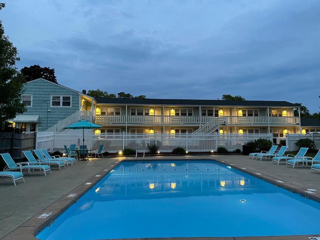 a hotel with a swimming pool in front of a building at The Escape Inn in South Yarmouth