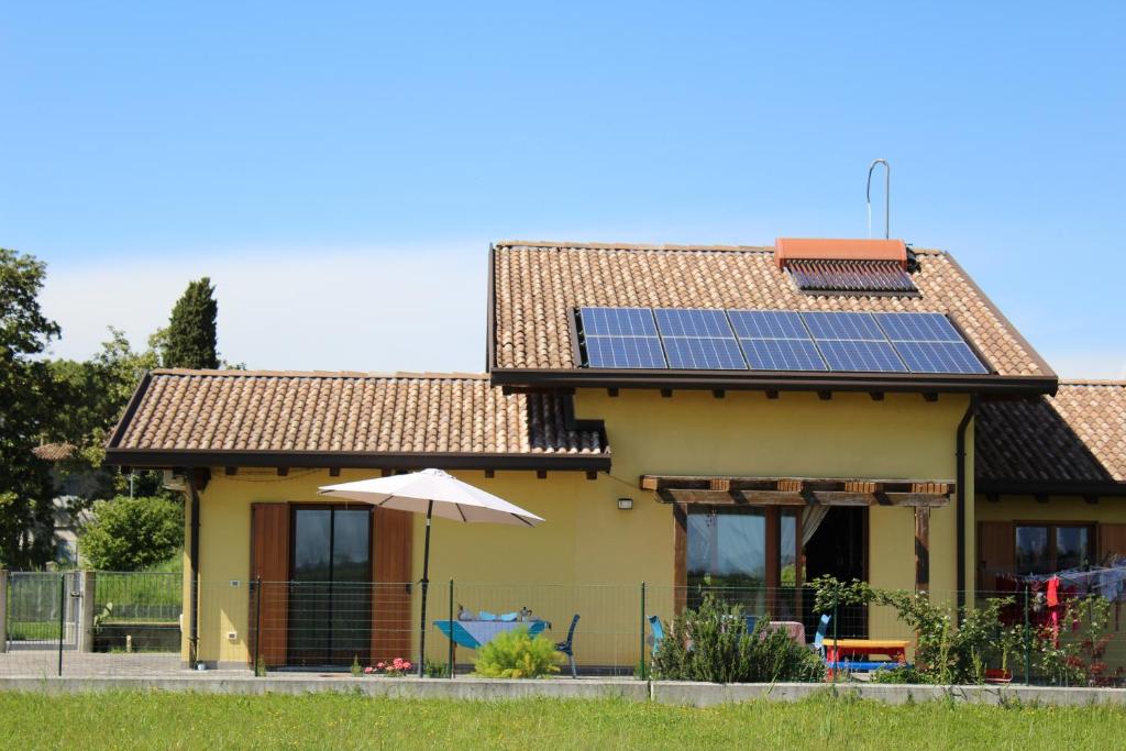 a house with solar panels on the roof at Villa Madi in San Lorenzo