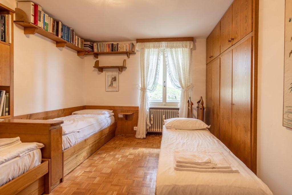 A bed or beds in a room at Casa Alverà