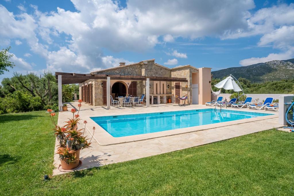an external view of a villa with a swimming pool at Finca Soliva in Capdepera