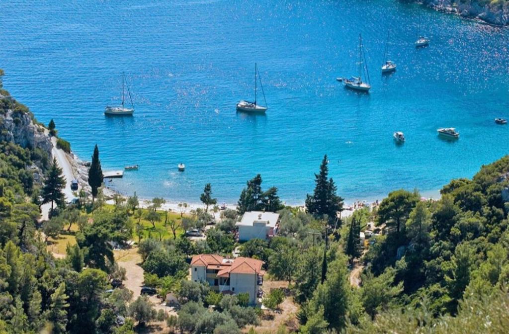 a view of a beach with boats in the water at Limnonari Beach Rooms in Skopelos Town