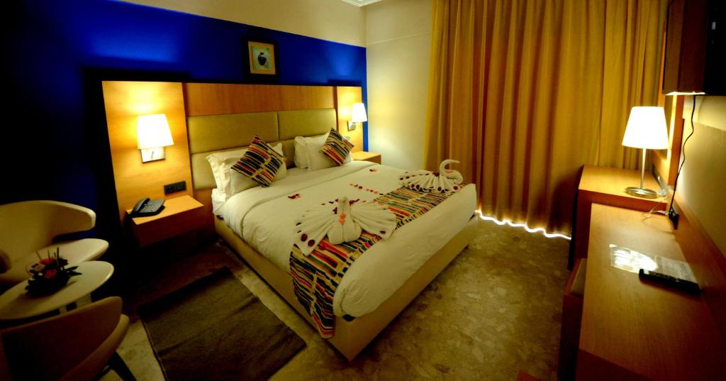 Postel nebo postele na pokoji v ubytování Oasis Hotel & Spa
