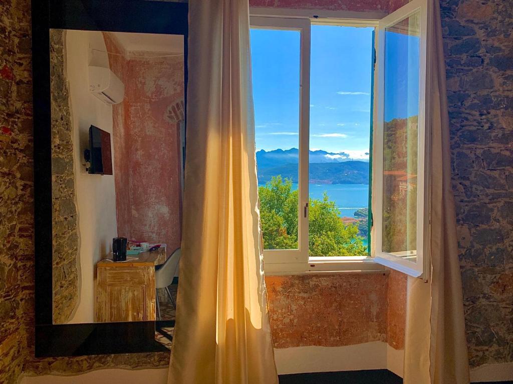 a window in a room with a view of the ocean at Tenuta di Venere in Portovenere