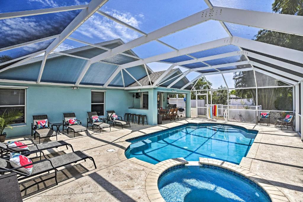a swimming pool with a retractable roof at Modern Beach Retreat with Pool, Hot Tub, and Patio! in Fort Myers
