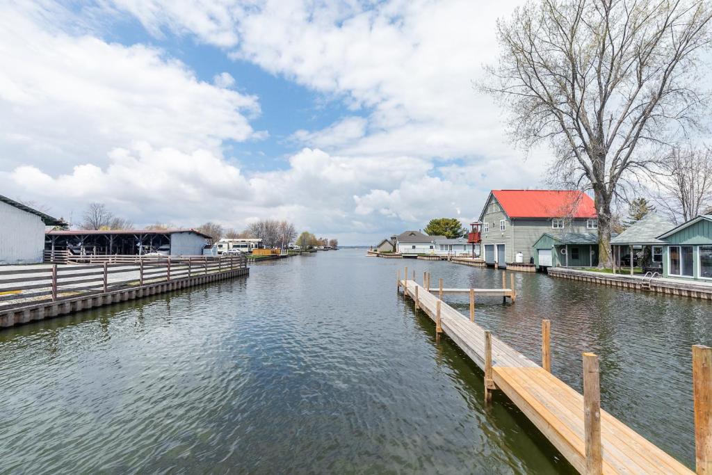 a body of water with houses and a dock at Bayside Cottage Rentals in Port Rowan