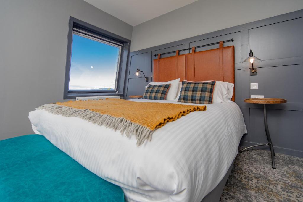 a bedroom with a large bed and a window at Hebridean Inn in Broadford