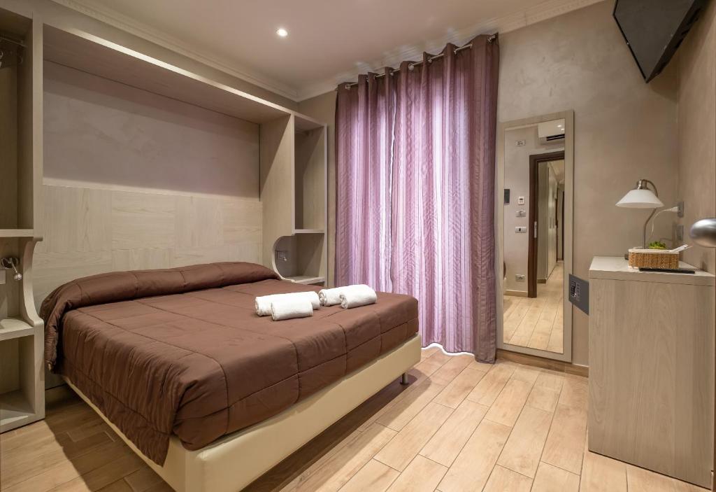 A bed or beds in a room at Nanà