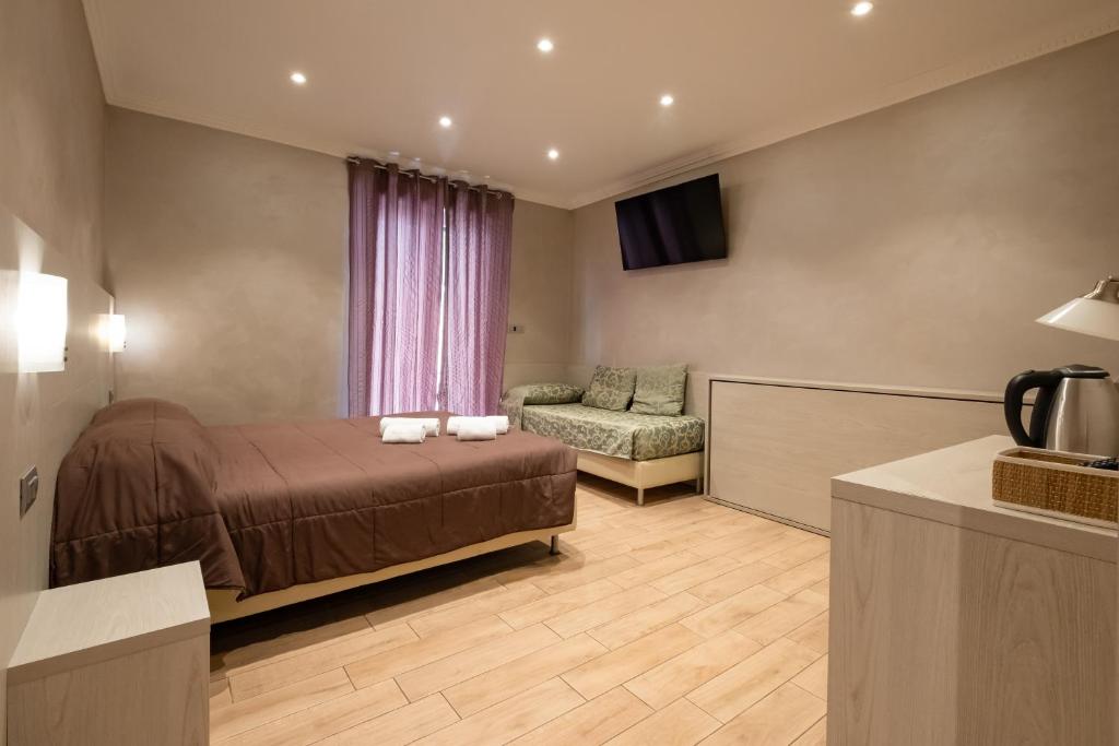 A bed or beds in a room at Nanà