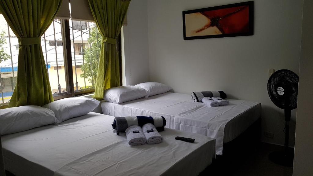 Postel nebo postele na pokoji v ubytování Hotel Laureles Home