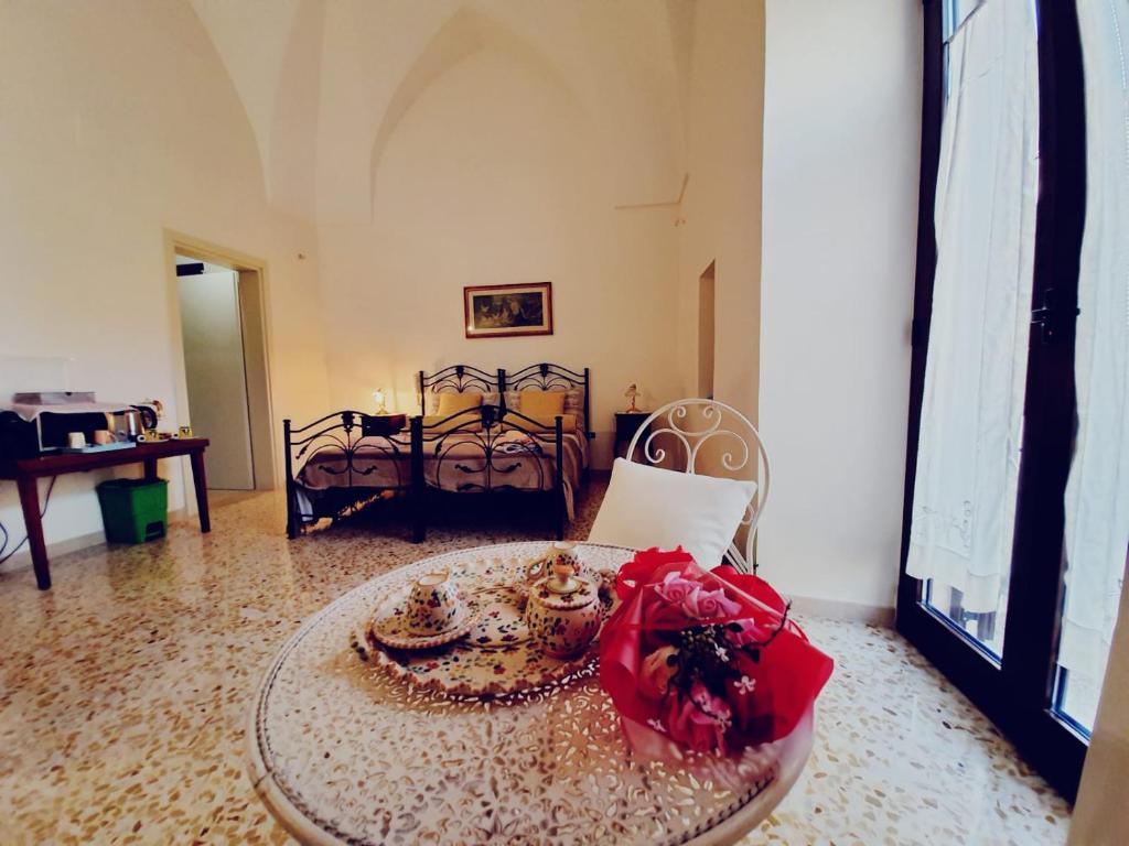 a room with a table with a red bow on it at camera matrimoniale centro storico Galatina in Galatina
