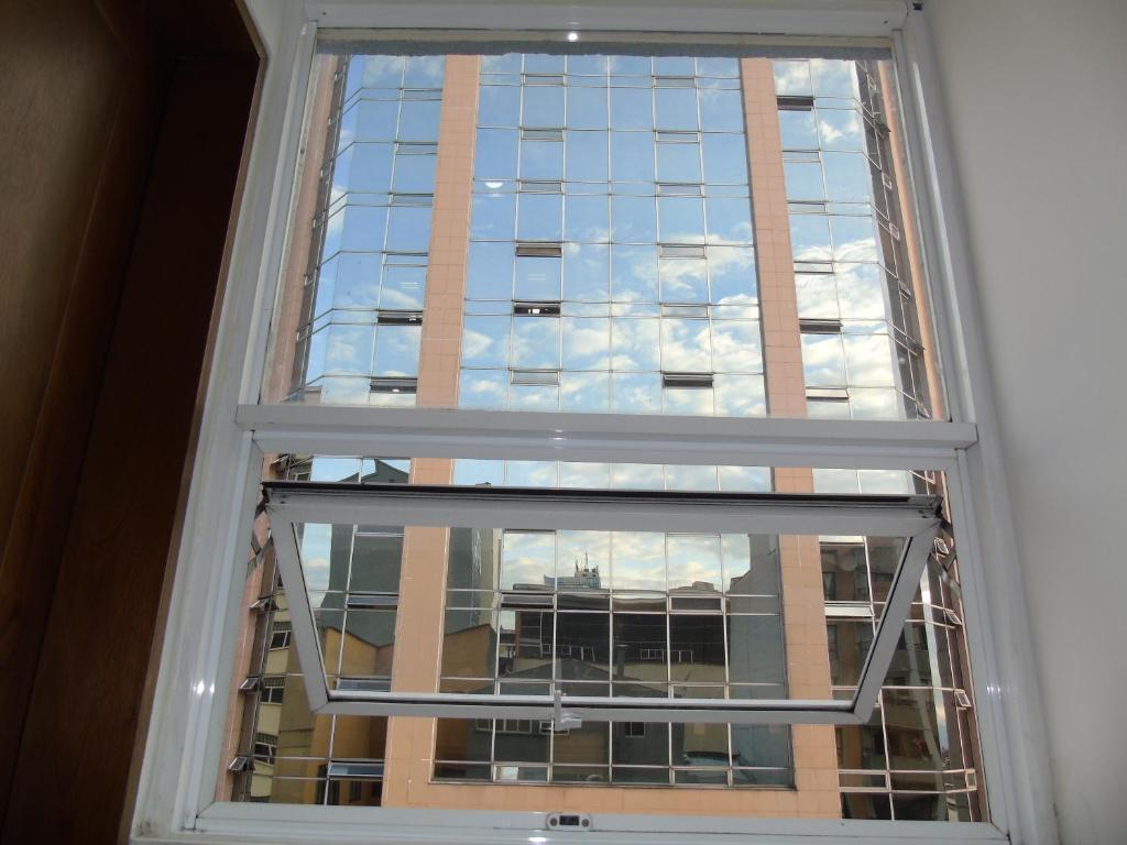 a window with a view of a building at Hotel Paradise del Cafe in Pereira
