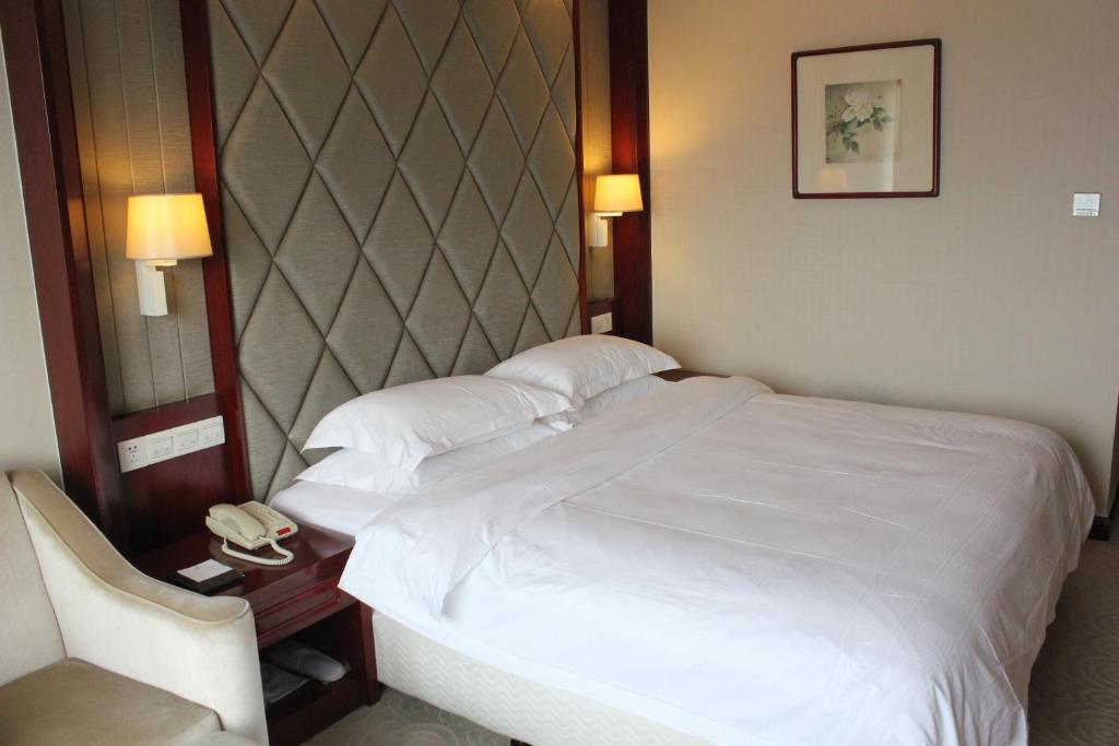 Ein Bett oder Betten in einem Zimmer der Unterkunft Jinyuan Jinling Plaza Xuzhou
