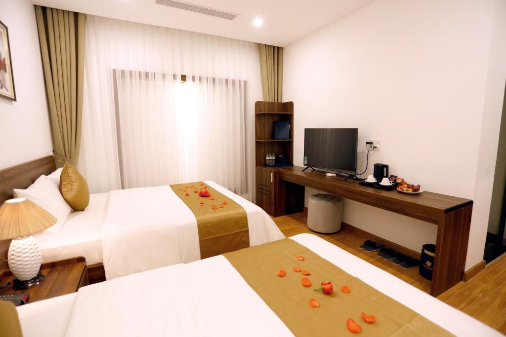 Giường trong phòng chung tại Silk River Hotel Ha Giang