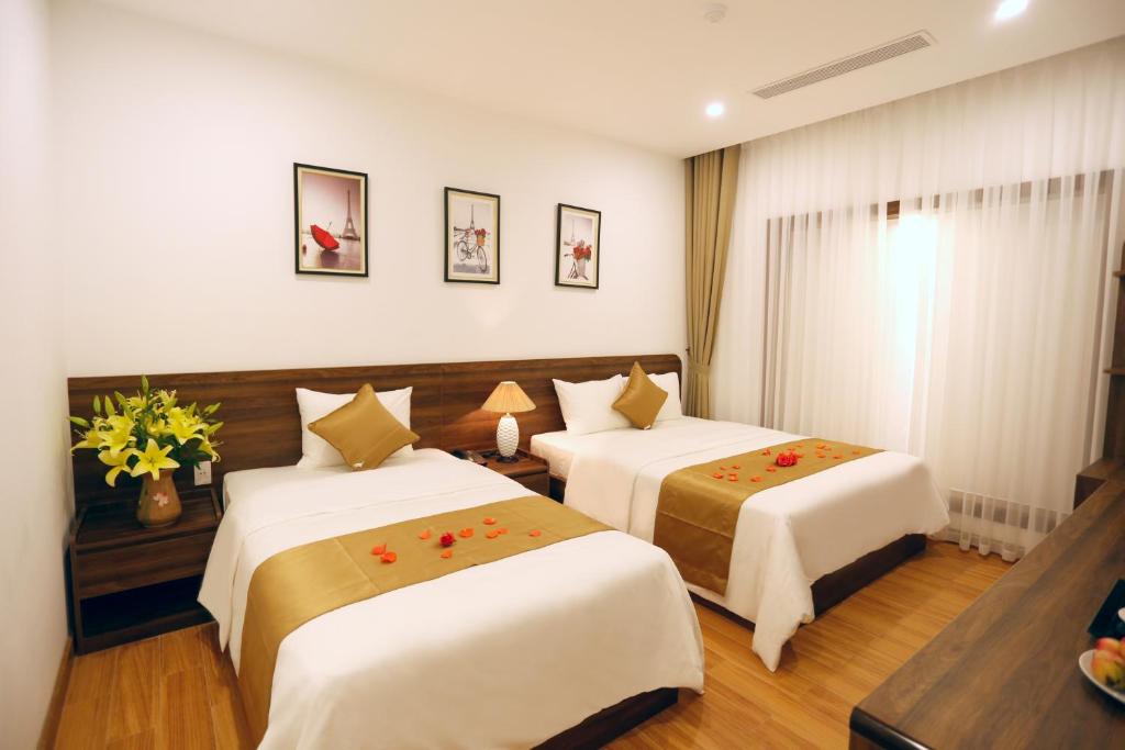 Giường trong phòng chung tại Silk River Hotel Ha Giang