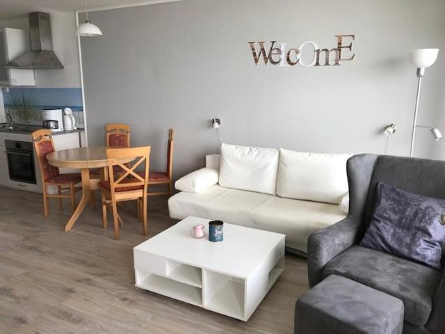 a living room with a couch and a table at Strandhotel Wohnung 68 in Dahme