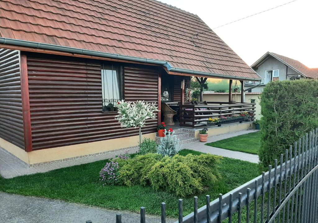 a small house with a fence in front of it at Holiday Home Di More in Jagodina