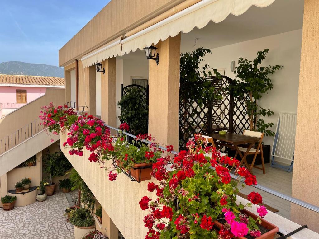 a balcony with flowers on the side of a building at B&b il Patio in Villasimius