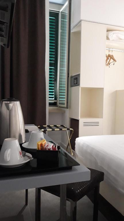 Postel nebo postele na pokoji v ubytování Crosti Hotel