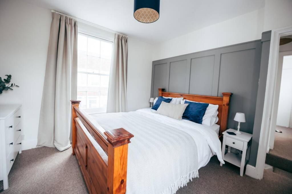 a bedroom with a large bed with blue pillows at City Centre Secret in Kent