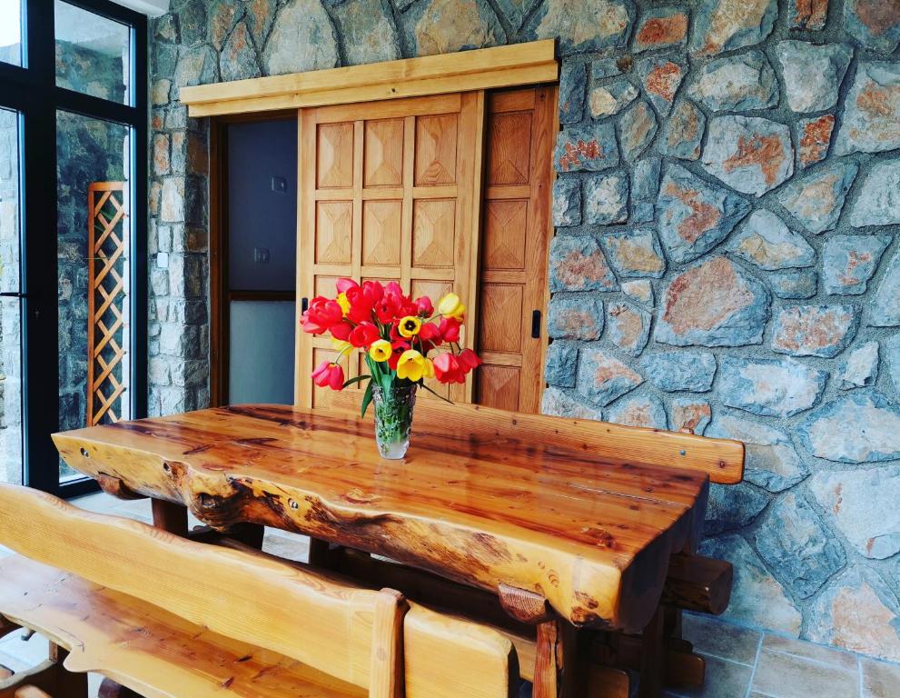 a vase of flowers sitting on a wooden table at Apartments Sandra in Lovran