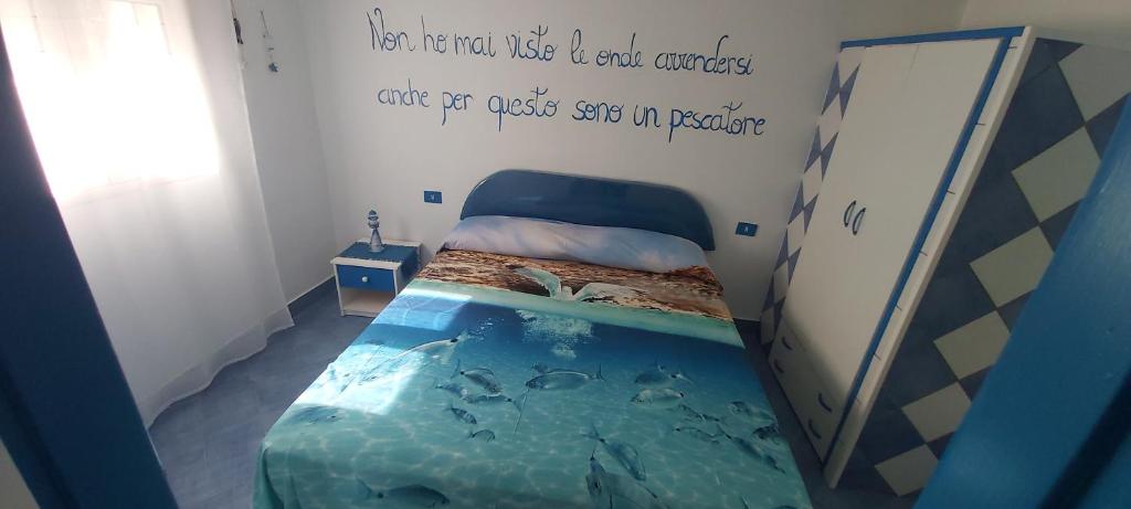 a bedroom with an underwater bed with an aquarium in it at I Mosaici Lampedusa in Lampedusa