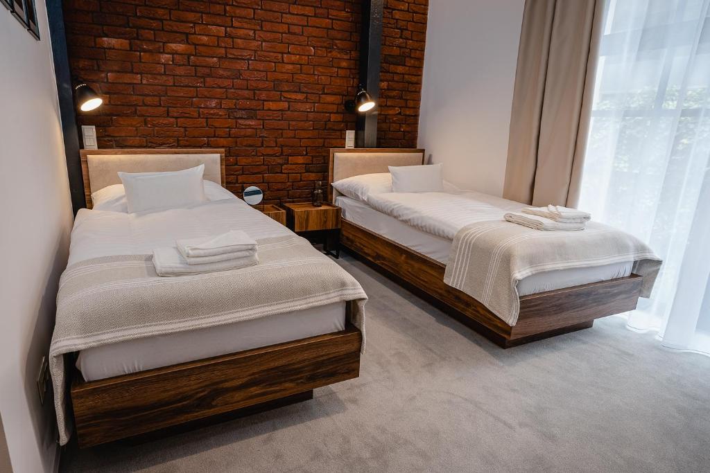 Postel nebo postele na pokoji v ubytování Garni Hotel DOCK Bratislava