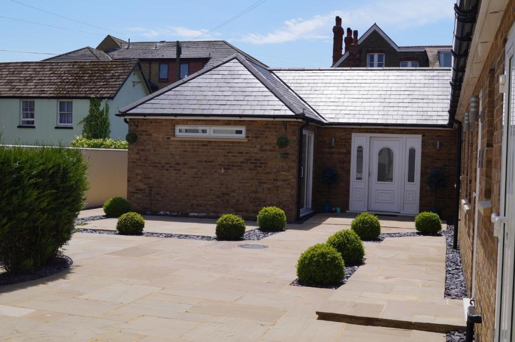 a house with a brick driveway and a garage at Viking Villa in Broadstairs