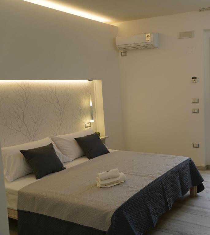 Postel nebo postele na pokoji v ubytování FamiliaINN Rooms & Apartments