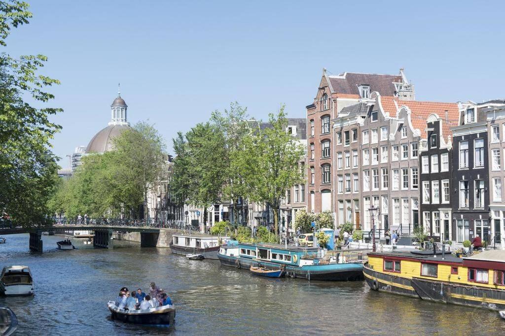 een groep mensen in een boot op een rivier bij Stylish Canalhouse A in Amsterdam